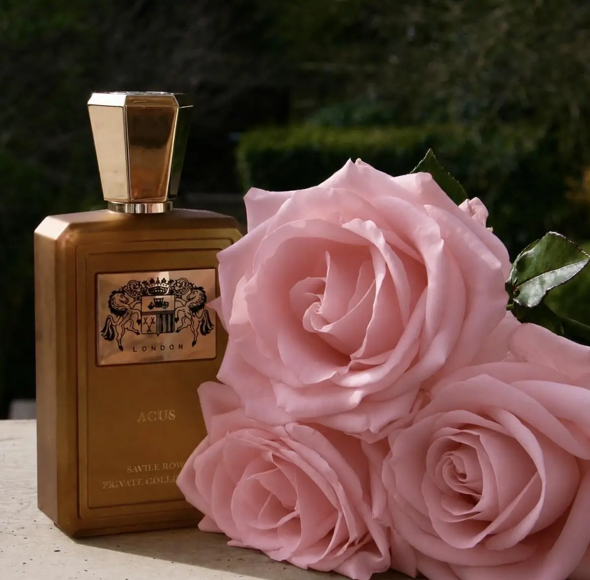 Acus Extrait de Parfum photographed with pink roses