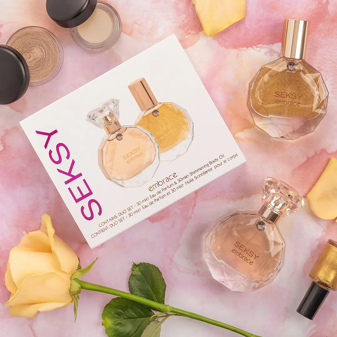 Seksy fragrances and gift set arranged with roses and petals on a peach ground