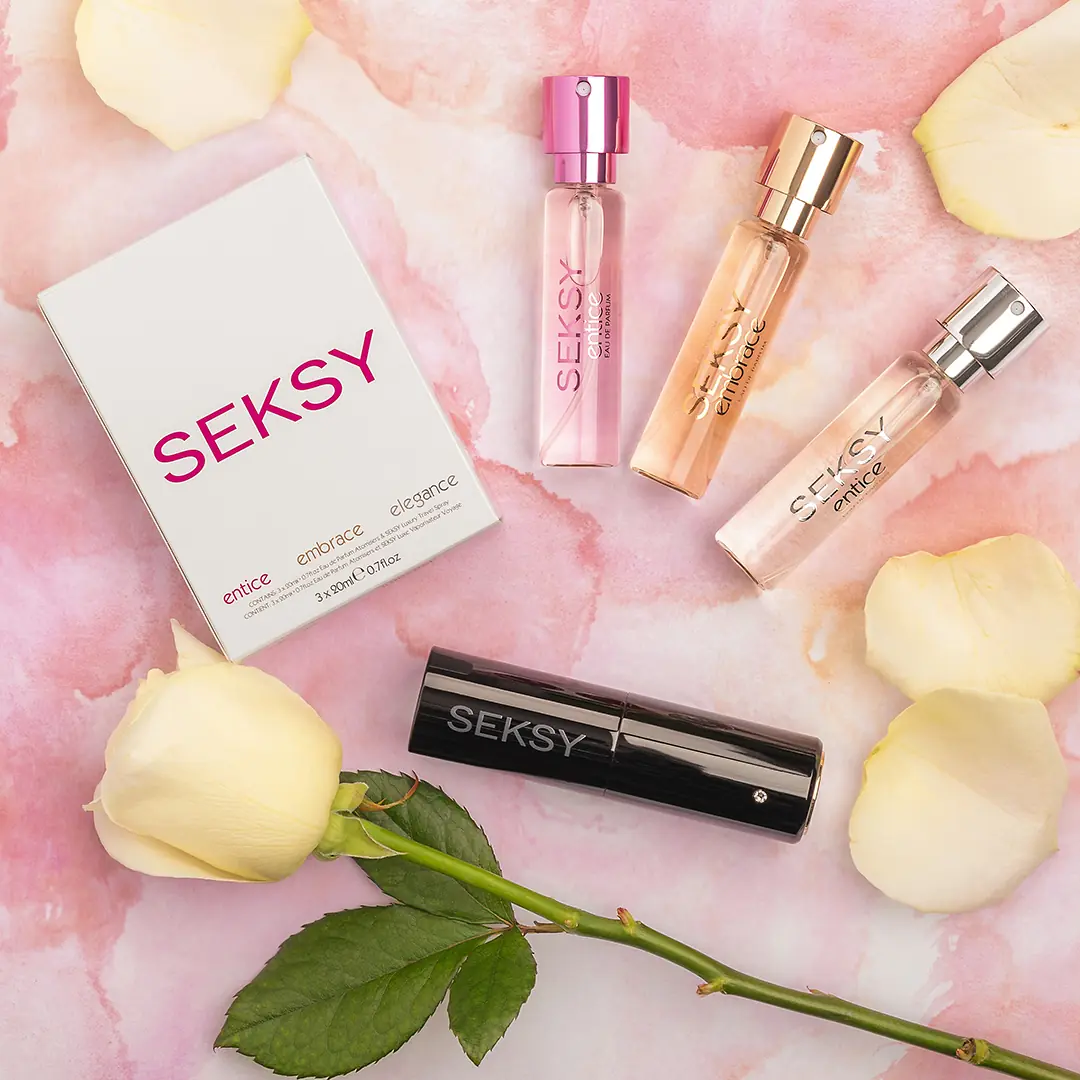 Seksy fragrance, roll-on and mascara arranged with a rose on a pink ground